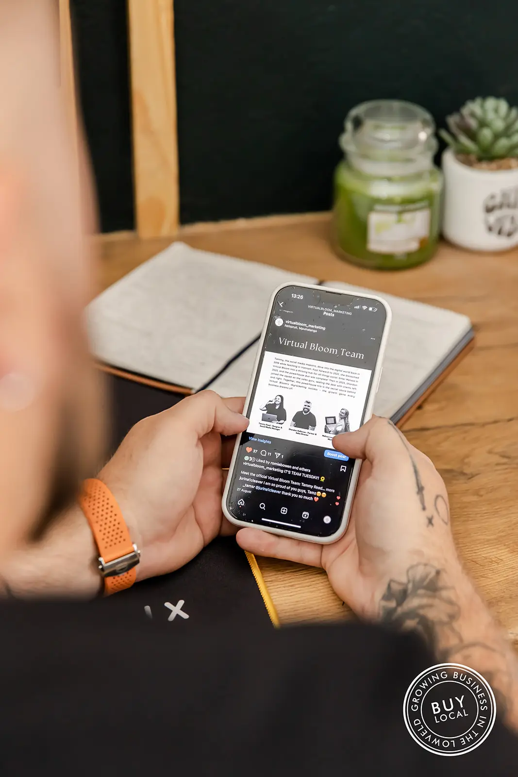 Picture of a phone showing the Virtual Bloom Instagram page
