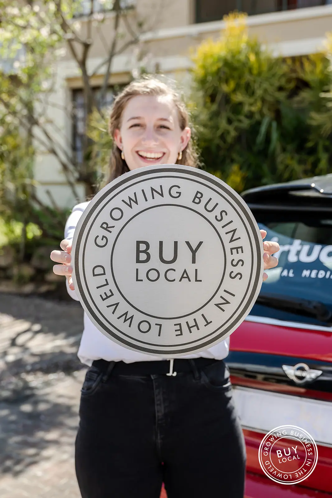 Picture of Melissa holding the Buy Local Lowveld logo