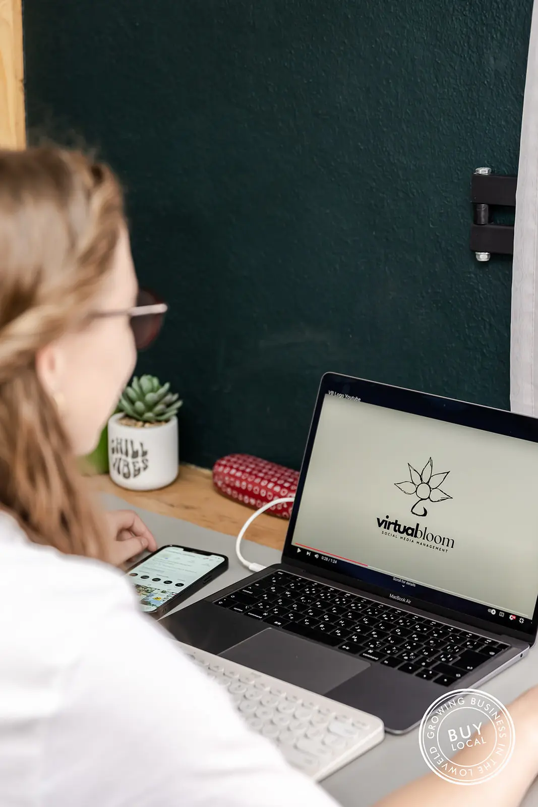A laptop screen showing the Virtual Bloom logo