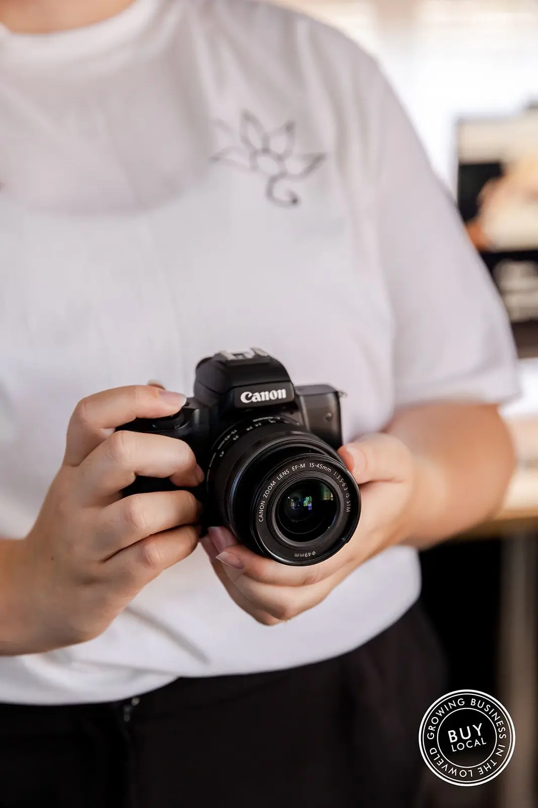 A close-up of Tammy holding a camera