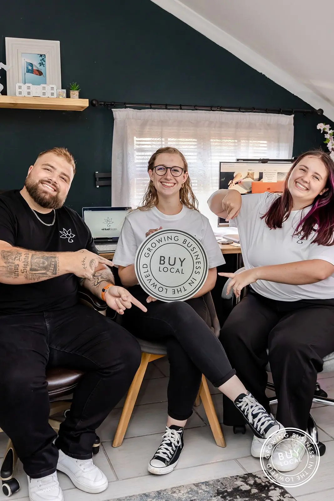 Shandon, Melissa, and Tammy holding the Buy Local Lowveld logo